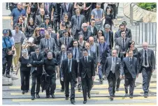  ?? AFP ?? Lawyers and members of the election committee’s legal sector hold a silent march in Hong Kong yesterday.