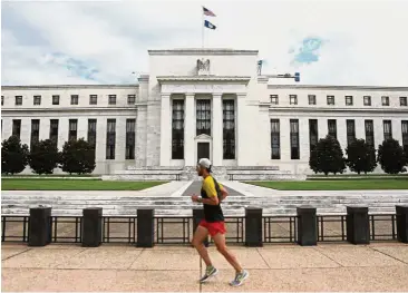  ??  ?? Low rate: A jogger runs past the Federal Reserve building in Washington, DC. From the end of 2008 through 2015, the Federal Reserve kept short-term interest rates at or near zero.