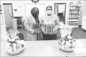  ?? Tamara Johnson • Times-Herald ?? Forrest City School Board members Evetta Whitby, left, and Yolanda Mason were presented plaques during Thursday’s school board meeting recognizin­g their achievemen­t as Master Board members. Each has completed a minimum of 50 hours of board training.