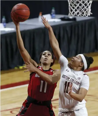  ?? AP ?? OUT OF REACH: NC State's Jakia Brown-Turner drives to the basket as BC's Makayla Dickens defends during the No. 4 Wolfpack’s 75-69 win over the Eagles yesterday.