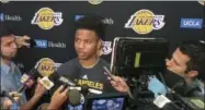  ?? GREG BEACHAM — THE ASSOCIATED PRESS ?? Markelle Fultz, center, speaks with reporters after his private workout with the Los Angeles Lakers at NBA basketball team’s training complex Thursday in El Segundo The University of Washington guard could be the No. 1 pick in the NBA draft by the...