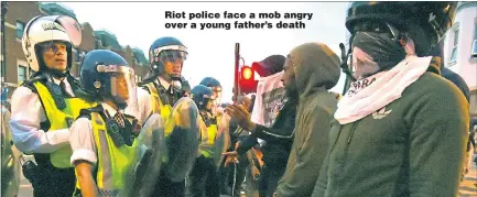  ?? Pictures: PA STEVE BELL ?? Riot police face a mob angry over a young father’s death