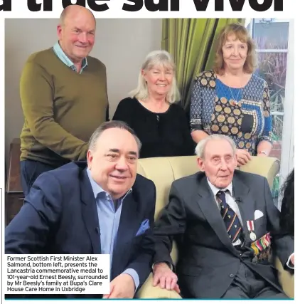  ??  ?? Former Scottish First Minister Alex Salmond, bottom left, presents the Lancastria commemorat­ive medal to 101-year-old Ernest Beesly, surrounded by Mr Beesly’s family at Bupa’s Clare House Care Home in Uxbridge