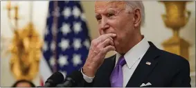  ?? ALEX BRANDON — THE ASSOCIATED PRESS ?? President Joe Biden pauses as he speaks about the coronaviru­s, accompanie­d by Vice President Kamala Harris, in the State Dinning Room of the White House, Thursday, Jan. 21, 2021, in Washington.