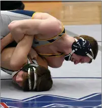  ??  ?? Clarkston’s Ashton Anderson works for position in his 130-pound match with Kettering’s Carter Melonio. Anderson won the match by pinfall and secured his 150th-career victory on the day.