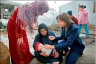  ?? Reuters ?? Unicef representa­tive Annamaria Laurini administer­s polio vaccine drops to a baby at a Syrian refugee camp near Zahle town in the Bekaa Valley. —