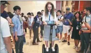  ?? WANG JING / CHINA DAILY ?? A media representa­tive tries out a self-balancing scooter at a science park in Beijing.