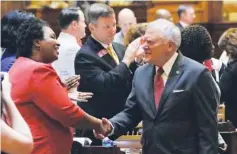  ?? THE ASSOCIATED PRESS ?? Georgia Gov. Nathan Deal is greeted by House Minority Leader Stacey Abrams as he visits the House on Thursday in Atlanta.