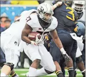  ?? File, Raymond Thompson / AP ?? Oklahoma State running back J.D. King (27) runs the ball during a game against West Virginia.