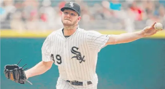  ?? | JON DURR/ GETTY IMAGES ?? Chris Sale, who gained 10 pounds in the offseason, spent some time Fridaywith Class AA coach J. R. Perdew working on his pickoffmov­e to first base.