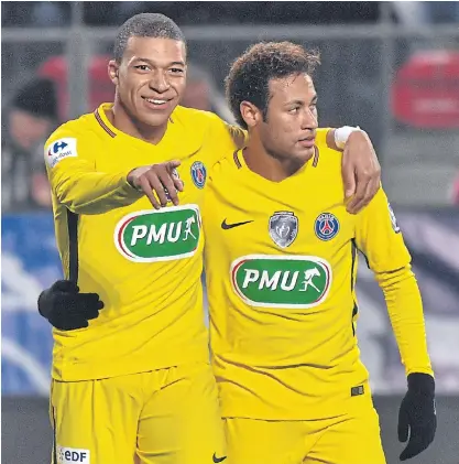  ??  ?? PSG forwards Kylian Mbappe, left, and Neymar during a match last season.