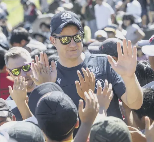  ??  ?? Scottish Rugby chief executive Dominic Mckay high-fives kids at a coaching clinic during the Rugby World Cup in 2019