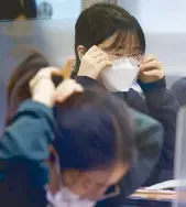  ?? AP ?? A student takes the annual college entrance examinatio­n in Seoul yesterday.