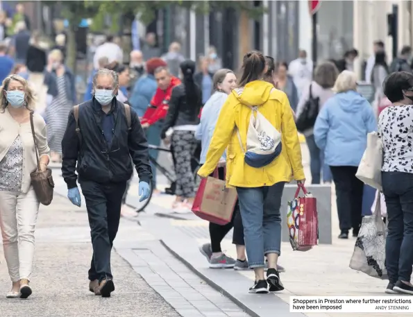  ?? ANDY STENNING ?? Shoppers in Preston where further restrictio­ns have been imposed