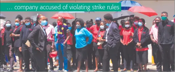  ?? Photo: Maria Amakali ?? Up in arms… Striking Shoprite, Checkers and Usave workers outside the High Court yesterday.