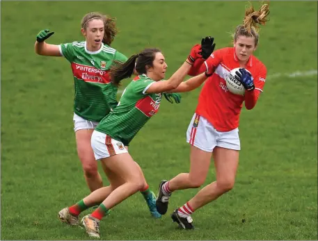  ??  ?? Maire O’Callaghan of Cork in action against Niamh Kelly, centre, and Sinéad Cafferky of Mayo during their Lidl Ladies NFL Round 6 match at Elverys MacHale Park in Castlebar. Photo by Sportsfile