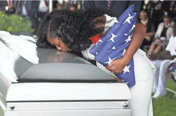  ?? JOE ?? Myeshia Johnson kisses the casket of her husband, U.S. Army Sgt. La David Johnson, during his burial service at the Memorial Gardens East cemetery in Hollywood, Fla., on Saturday.