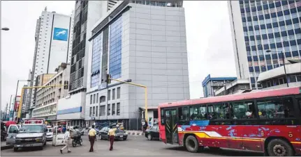  ??  ?? A city bus drives past office buildings in Lagos, Nigeria (file). Africa is seen as a particular area of potential growth for Islamic banking. Northern African countries such as Morocco and Algeria have seen the launch of several Islamic banking subsidiari­es and windows in the recent past, while sub-Saharan countries such as Nigeria, Senegal and Kenya have also implemente­d legal and regulatory frameworks to spur growth in the Islamic banking sector.