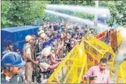  ?? PTI ?? Police use water cannons to disperse farmers during a protest in Karnal on Tuesday.