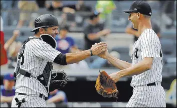  ?? Julie Jacobson The Associated Press ?? Yankees catcher Austin Romine greets reliever Chasen Shreve after the Bonanza High product recorded the final three outs of a 7-6 win over the Mets on Saturday.