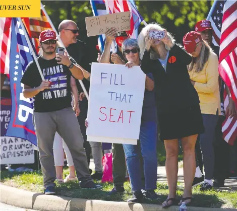  ?? PATRICK SEMANSKY / THE ASSOCIATED PRESS ?? Supporters of U.S. President Donald Trump gather outside Trump National Golf Club in Sterling, Va., on Sunday, showing their support for a quick confirmati­on of a new Supreme Court justice in the wake of the death of Justice Ruth Bader Ginsburg.