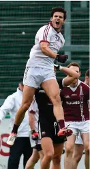  ??  ?? Slaughtnei­l’s Karl McKaigue celebrates at the final whistle