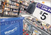  ?? ELISE AMENDOLA/CP PHOTO ?? In this June photo, a shopper looks at merchandis­e at a Walmart in Salem, N.H.