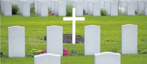  ?? SEAN KILPATRICK/THE CANADIAN PRESS ?? Military grave stones are pictured at a cemetery in Ottawa on Monday. The words on each grave marker are easy to read, even those carved decades ago, while the grey stones are all clean, the surroundin­g grass and flowers are trim and manicured. Such a...