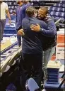  ?? David Borges / Hearst Connecticu­t Media ?? Maurice Clarett embraces UConn men’s basketball assistant coach Tom Moore prior to Saturday’s game at Xavier.