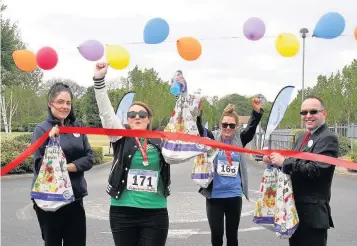  ?? Ramblers at Rainbow House’s annual Rainbow Ramble bagged themselves energy packs at the finish line courtesy of the Tesco Burscough Bridge store ??