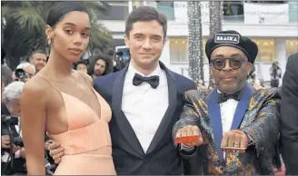  ?? Vianney Le Caer Invision / Associated Press ?? ACTORS Laura Harrier and Topher Grace, center, and director Spike Lee of “BlacKkKlan­sman.”