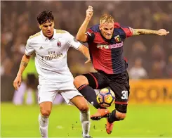  ?? — AFP ?? Genoa's midfileder­r Luca Rigoni (right) vies for the ball with AC Milan defender Gustavo Gomez on Tuesday.