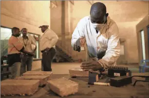  ?? PHOTO: BLOOMBERG ?? A worker uses a hammer and a letter punch to engrave gold bars with identifyin­g marks at the Kibali gold mine, operated by Randgold Resources, in Kibali, Democratic Republic of Congo.