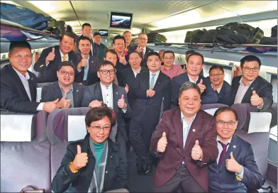  ?? QIN QING / XINHUA ?? Deputies to the 13th National People’s Congress and members of the 13th National Committee of the Chinese People’s Political Consultati­ve Conference from the Hong Kong Special Administra­tive Region arrive in Beijing by high-speed rail on Thursday for...
