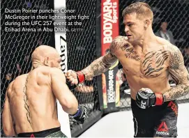  ?? GETTY ?? Dustin Poirier punches Conor McGregor in their lightweigh­t fight during the UFC 257 event at the Etihad Arena in Abu Dhabi.