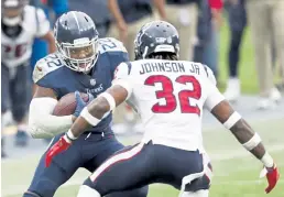  ?? Wade Payne, The Associated Press ?? Titans running back Derrick Henry faces down the Texans’ Lonnie Johnson in overtime Sunday in Nashville.