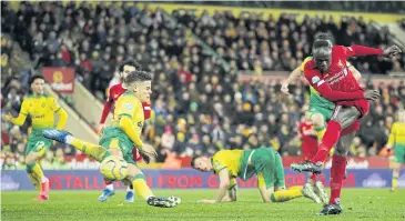  ?? REUTERS ?? Liverpool’s Sadio Mane, right, scores his team’s winning goal at Carrow Road.