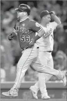  ??  ?? KOLE CALHOUN CIRCLES the bases after giving the Angels a 5-3 lead in the seventh inning with a solo home run.