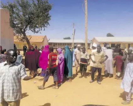  ?? (Photo: AP) ?? People gather inside the Government Science Secondary School in Kankara, Nigeria, Saturday after some 400 students were abducted by gunmen.