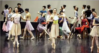  ?? PHOTOS BY JIANG DONG / CHINA DAILY Dream of the Red Chamber, ?? Clockwise from top left: Conductor Zhang Yi in a rehearsal for the ballet with the symphony orchestra of the National Ballet of China, in Beijing, on Feb 2; Qiu Yunting (left, starring as Lin Daiyu) and Li Wentao (starring as Jia Baoyu); Dancers of the National Ballet of China rehearse a scene from the production.