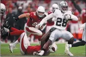  ?? CHRISTIAN PETERSEN — GETTY IMAGES ?? Raiders running back Josh Jacobs rushes past Arizona Cardinals linebacker Chandler Jones in Thursday’s game.