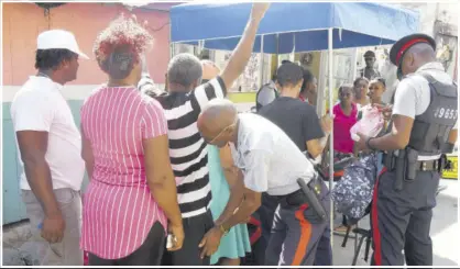  ?? ?? Police carry out searches in Denham Town, Kingston, where a zone of special operation has been declared.