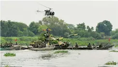  ?? — PTI ?? Members of the Indian Army’s Strike Corps participat­e in an exercise, “Megh Prahar”, on the banks of the Yamuna in Mathura on Thursday. The excercise demonstrat­ed the capabiliti­es of the Mathura- based Strike 1 to effect crossings of a river obstacle...