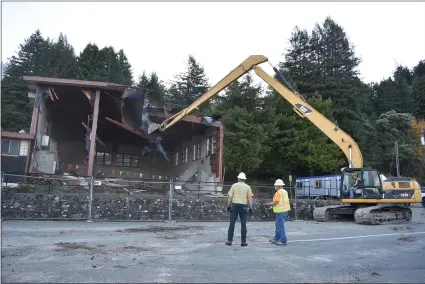  ?? MARY BULLWINKEL FOR THE TIMES-STANDARD ?? Going, going, gone! The demolition of the former Pacific Lumber Company recreation center is the first step toward the constructi­on of a new gymnasium for the Scotia Union School District.