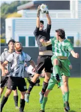  ?? ?? Te Puke goalkeeper Ben Day plucks a high ball out of the air.