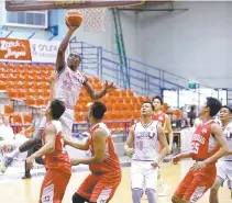  ?? PBA MEDIA BUREAU PHOTO ?? Rodrigue Ebondo of CEU shoots the ball past Jhygrus Laude of Team Batangas during the 2017 Philippine Basketball Associatio­n D- League Foundation Cup on Thursday at the Ynares Sports Arena in Pasig City.