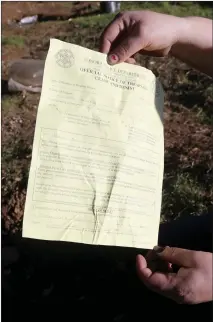  ?? Guy Mccarthy / Union Democrat ?? Jennifer Harkrader, 37, shows a trespass notice Monday she received from Sonora Police, who told Harkrader and her husband they have to move from their homeless camp next to Highway 108 and downhill from the back side of Lowe’s.
