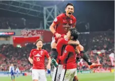  ??  ?? SHUJI KAJIYAMA/AP Players of Japan's Urawa Reds celebrate after scoring a goal against Al Hilal of Saudi Arabia during the second leg of the AFC Champions League final in Saitama Stadium in Saitama, Japan, on November 25, 2017.