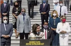  ??  ?? House Speaker Nancy Pelosi (above) speaks on the Capitol steps Thursday with members of the Congressio­nal Black Caucus.