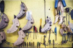  ??  ?? Boot-making tools hang in Deana McGuffin’s Albuquerqu­e shop.